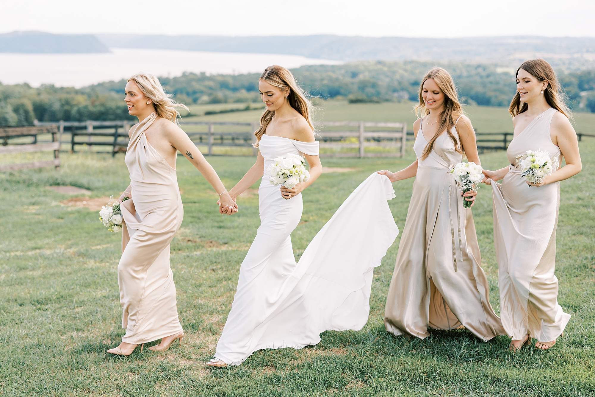 bridesmaids in champagne gowns walk with bride outside the Rotunda at Lauxmont Farms