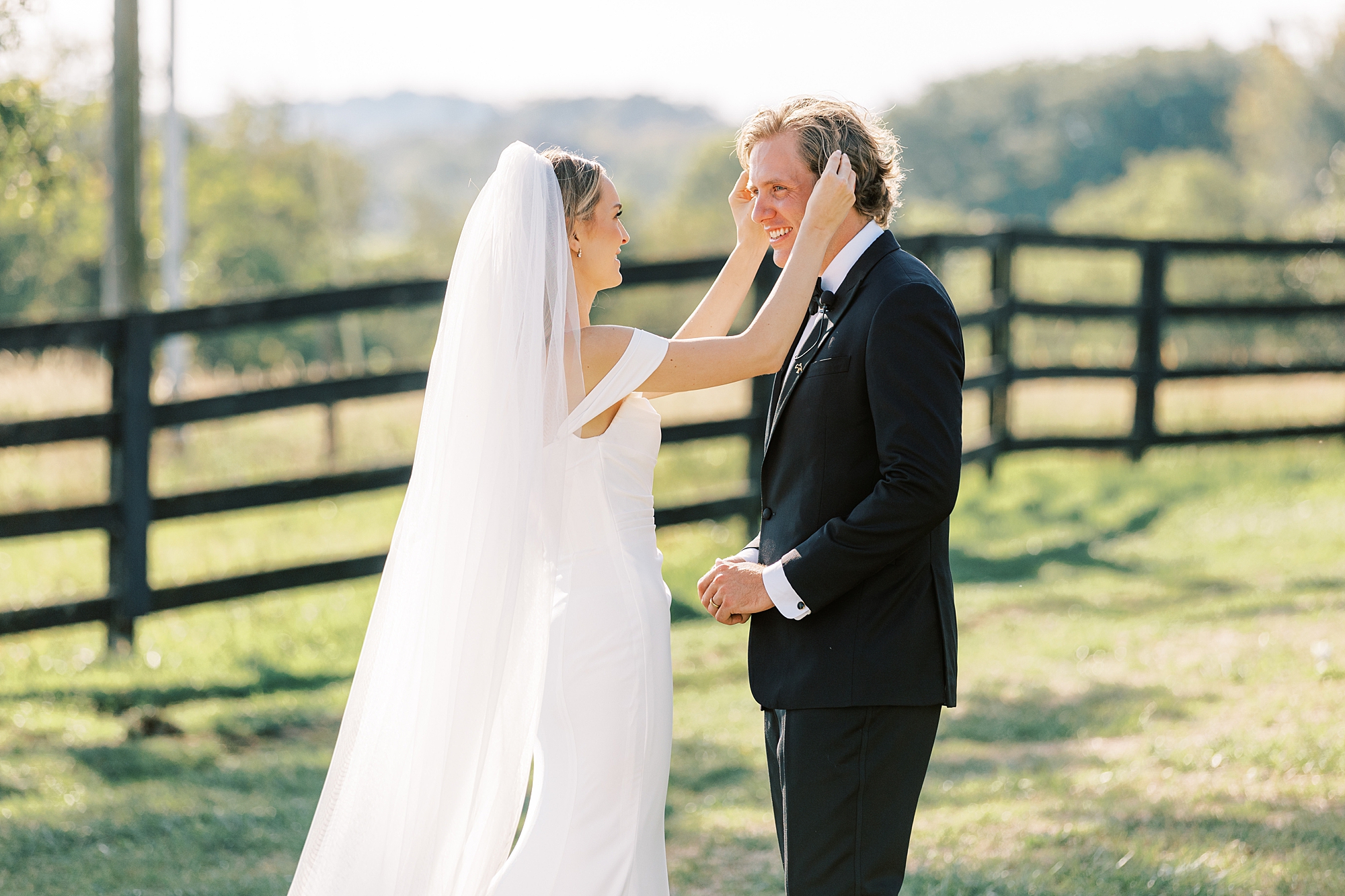 bride pushes groom's hair back at Lauxmont Farms