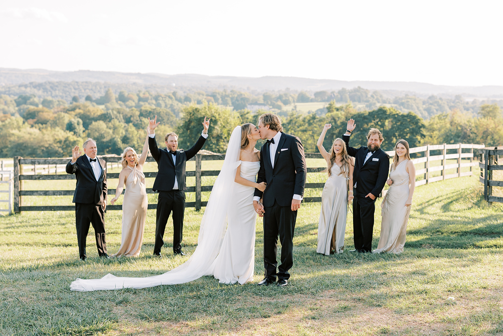 bride and groom kiss in front of wedding party during intimate wedding day at Lauxmont Farms