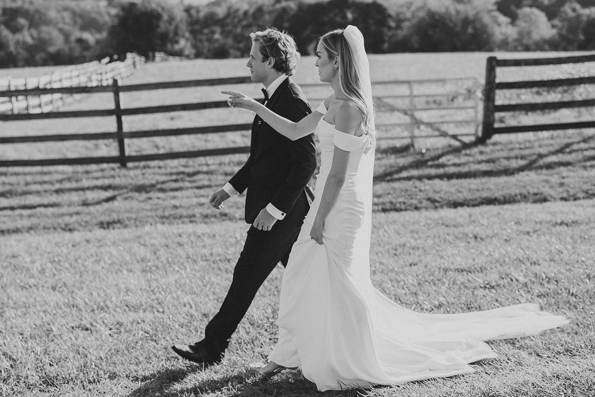 bride and groom walk across lawn at Lauxmont Farms