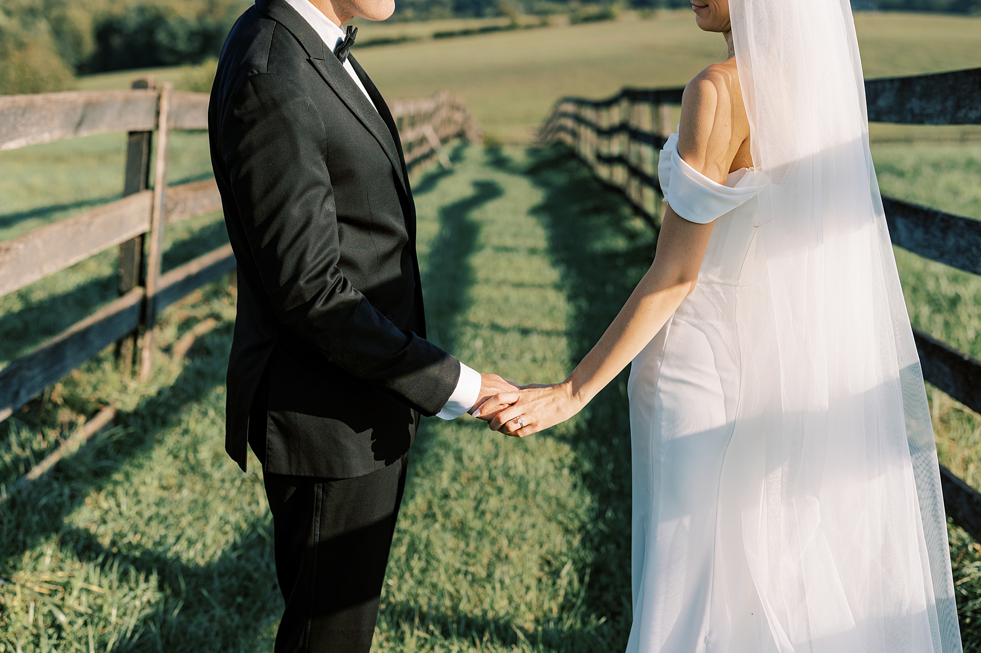 bride and groom hold hands during summer wedding day