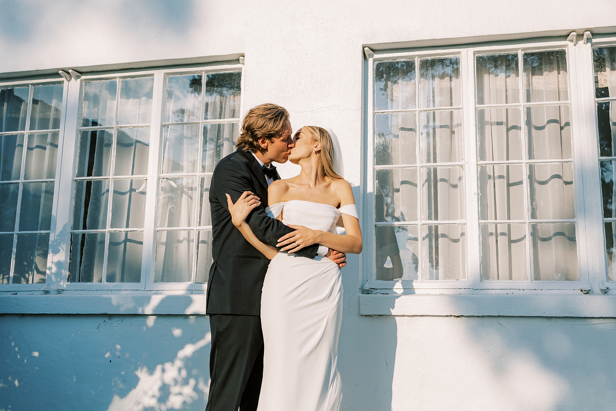 newlyweds hug and lean to kiss each other during PA wedding day