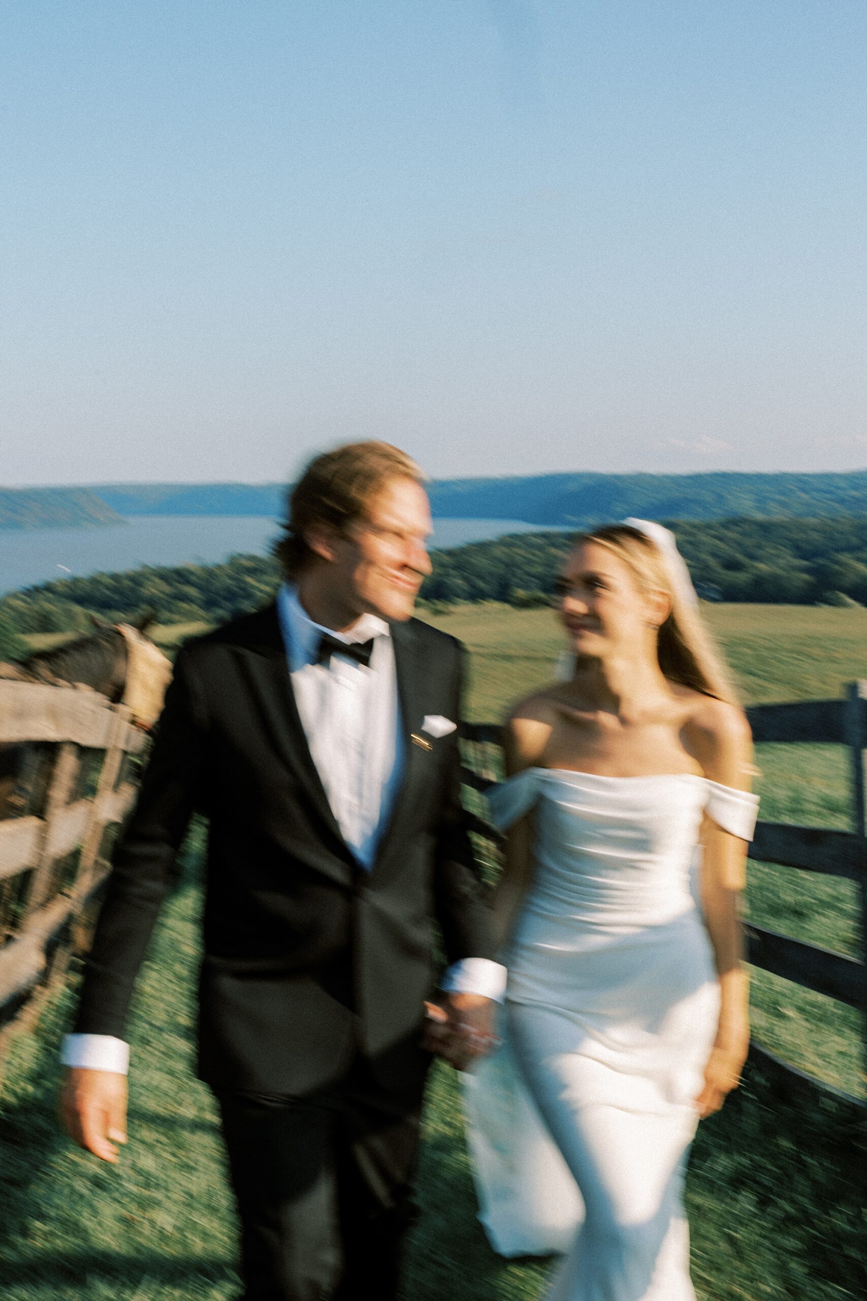 blurred photo of bride and groom walking on farm in PA