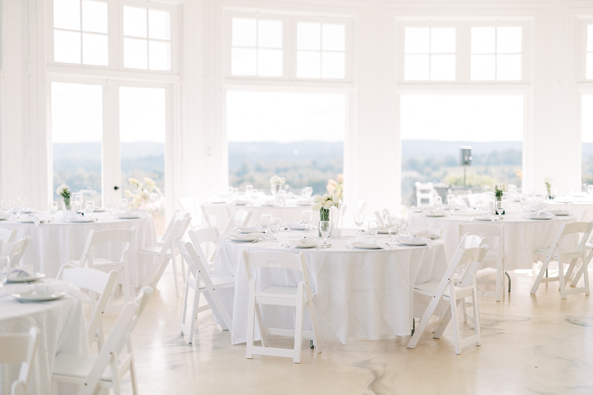 summer wedding reception with white place settings at Lauxmont Farms