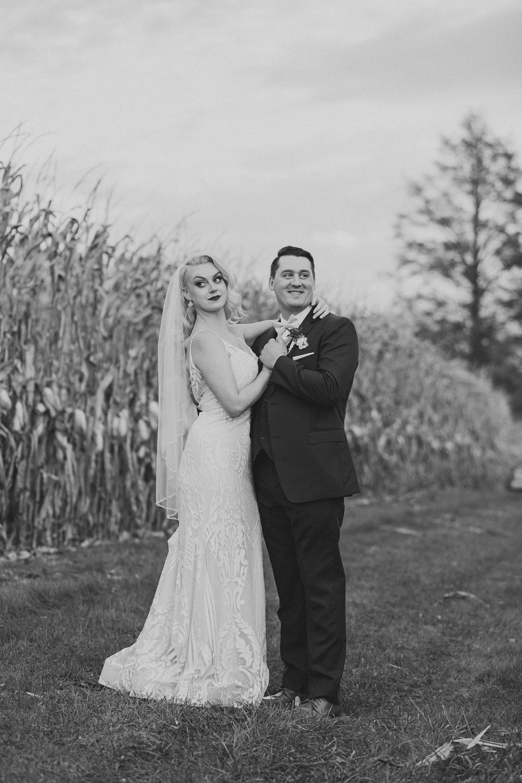 bride and groom hug between rows of cornstalks during Osbornia Farm wedding day