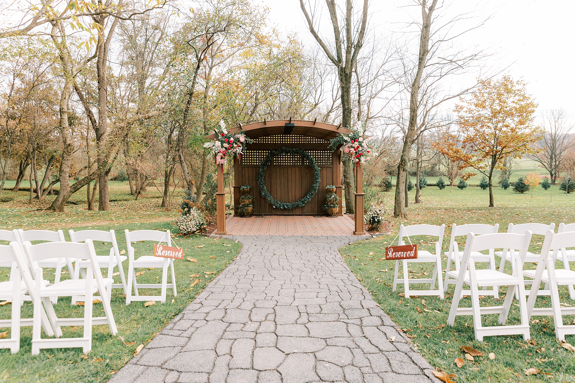 wedding ceremony site on lawn at Osbornia Farm with fall wedding flowers 