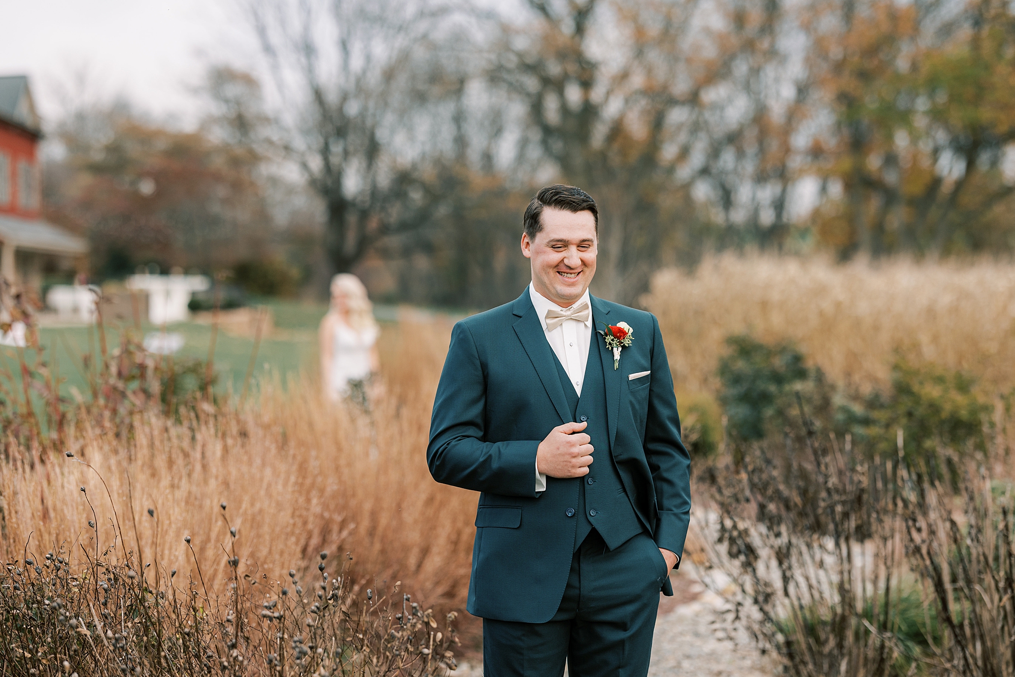 groom waits for first look in field at Osbornia Farm