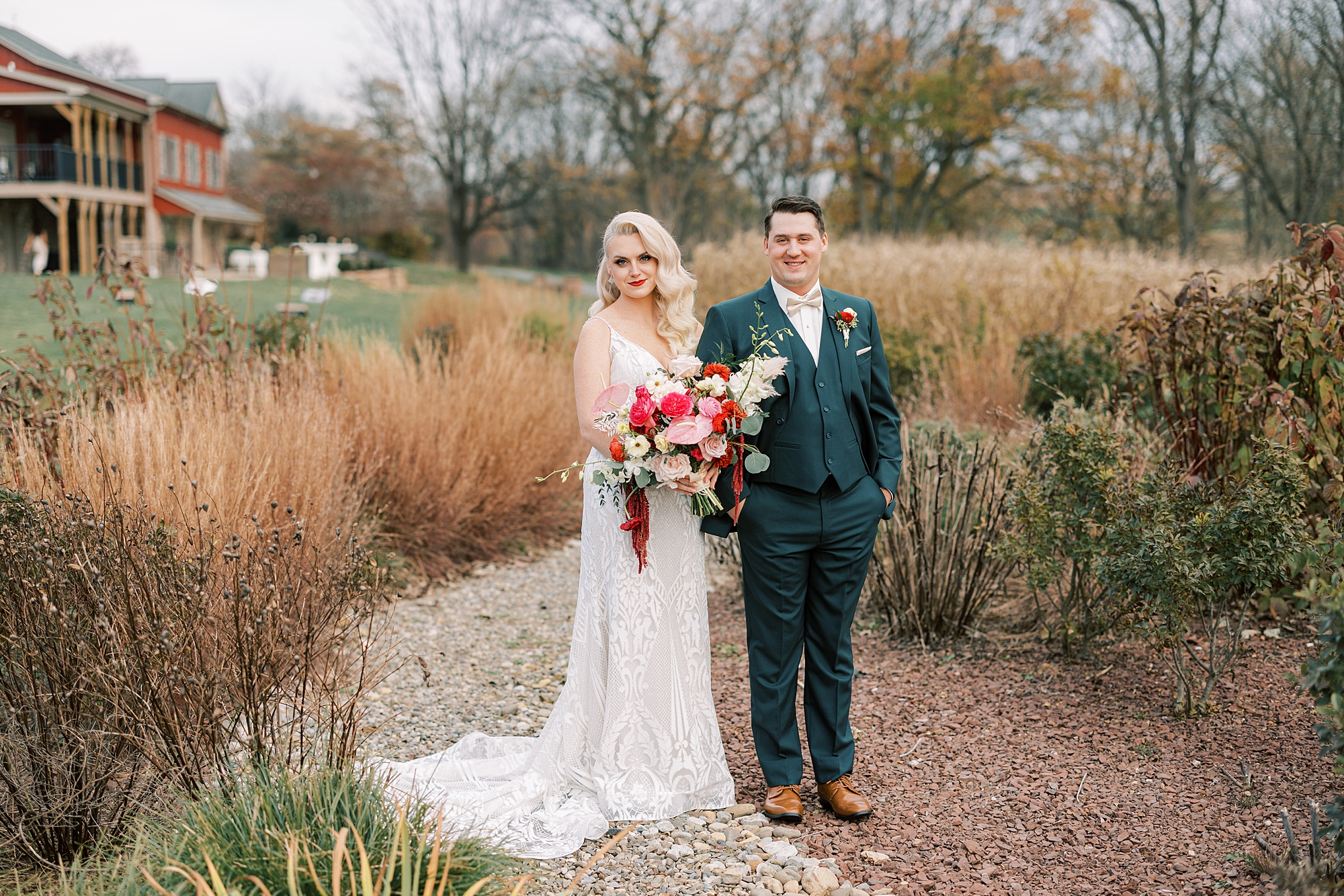 bride holds groom's arm in field at Osbornia Farm during fall wedding day