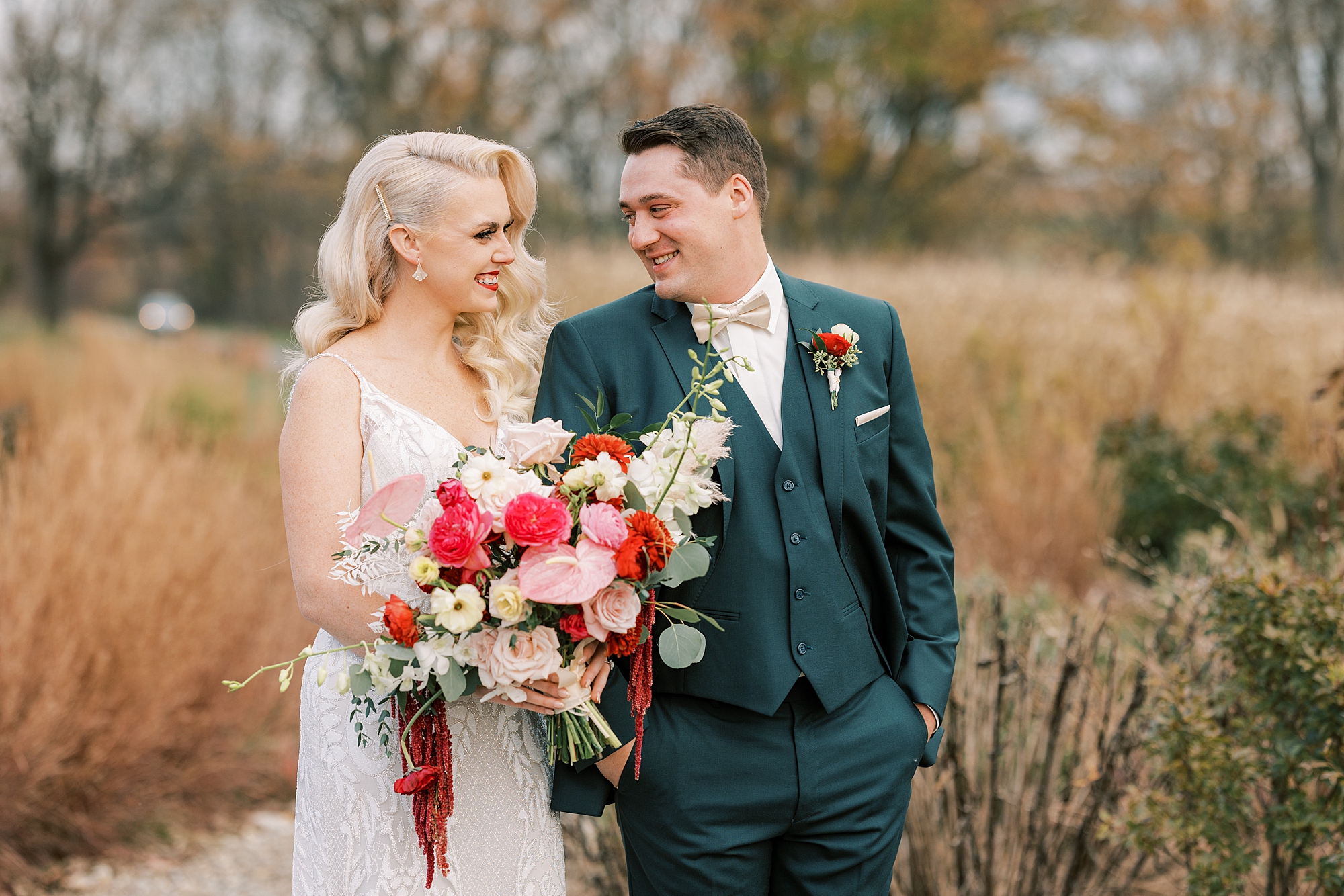 groom turns to look at bride during fall wedding portraits at Osbornia Farm