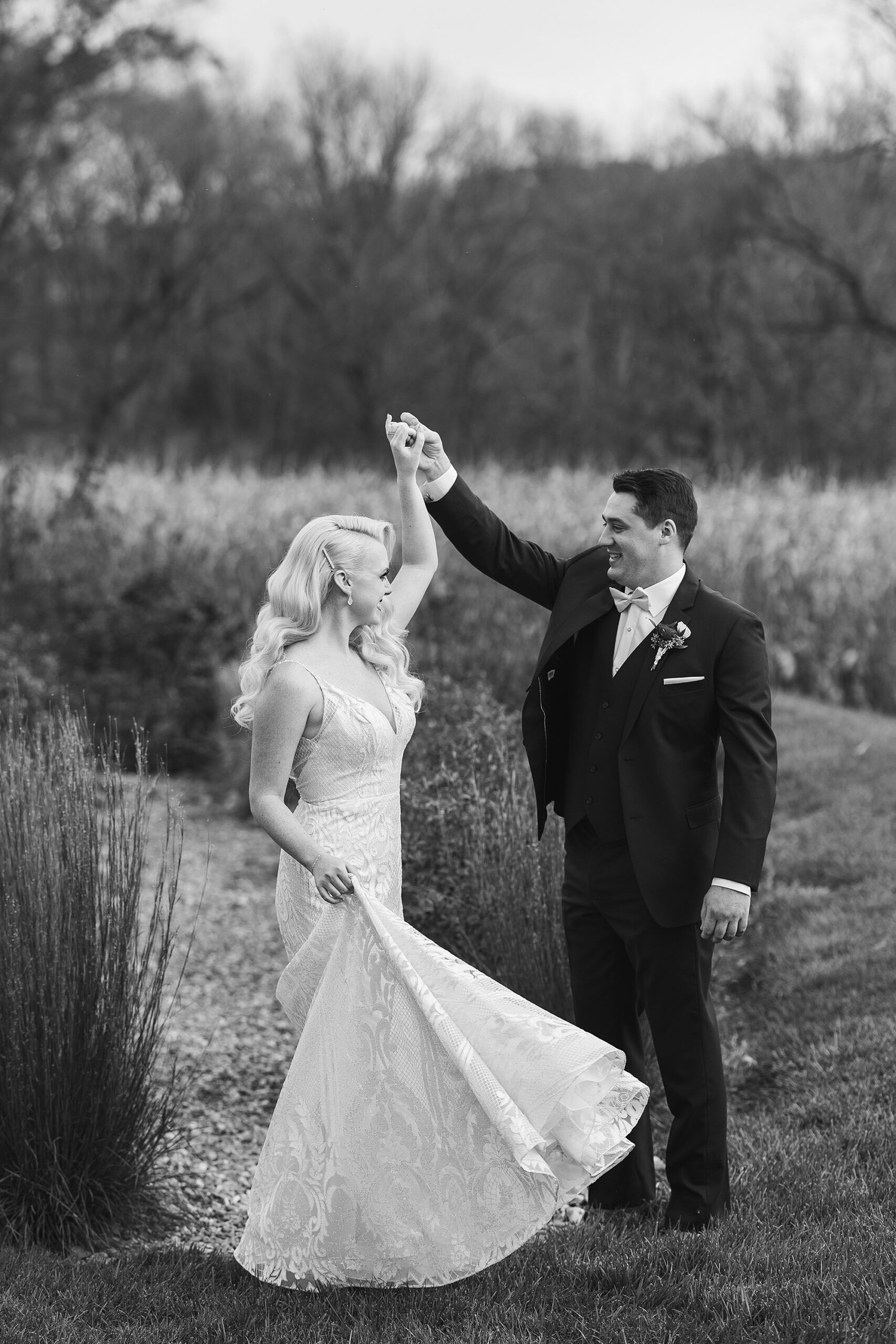 groom twirls bride during fall wedding day at Osbornia Farm