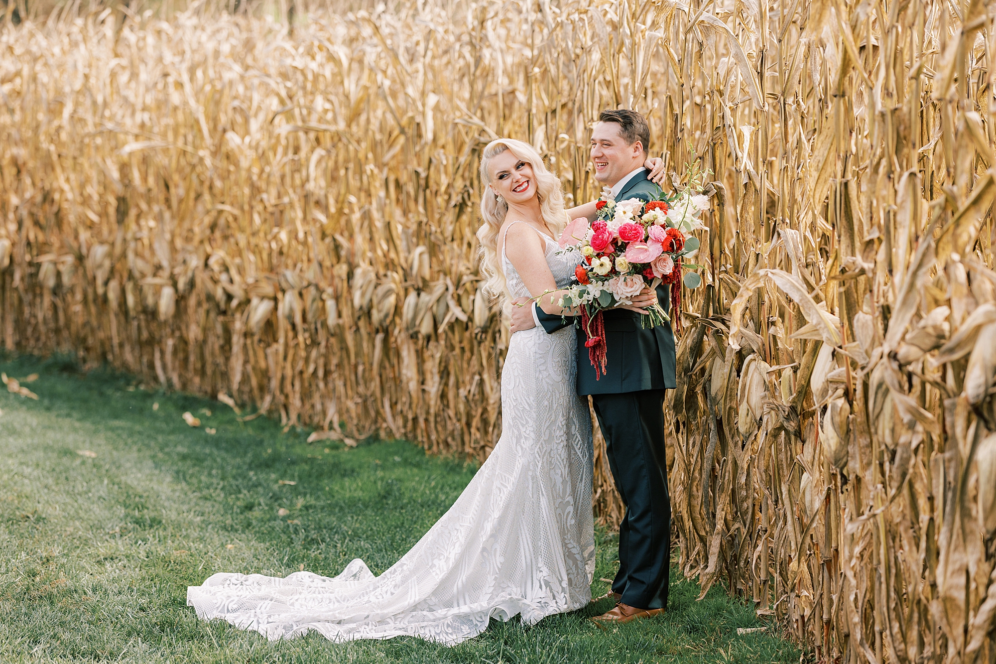 bride and groom hug against cornfields at Osbornia Farm