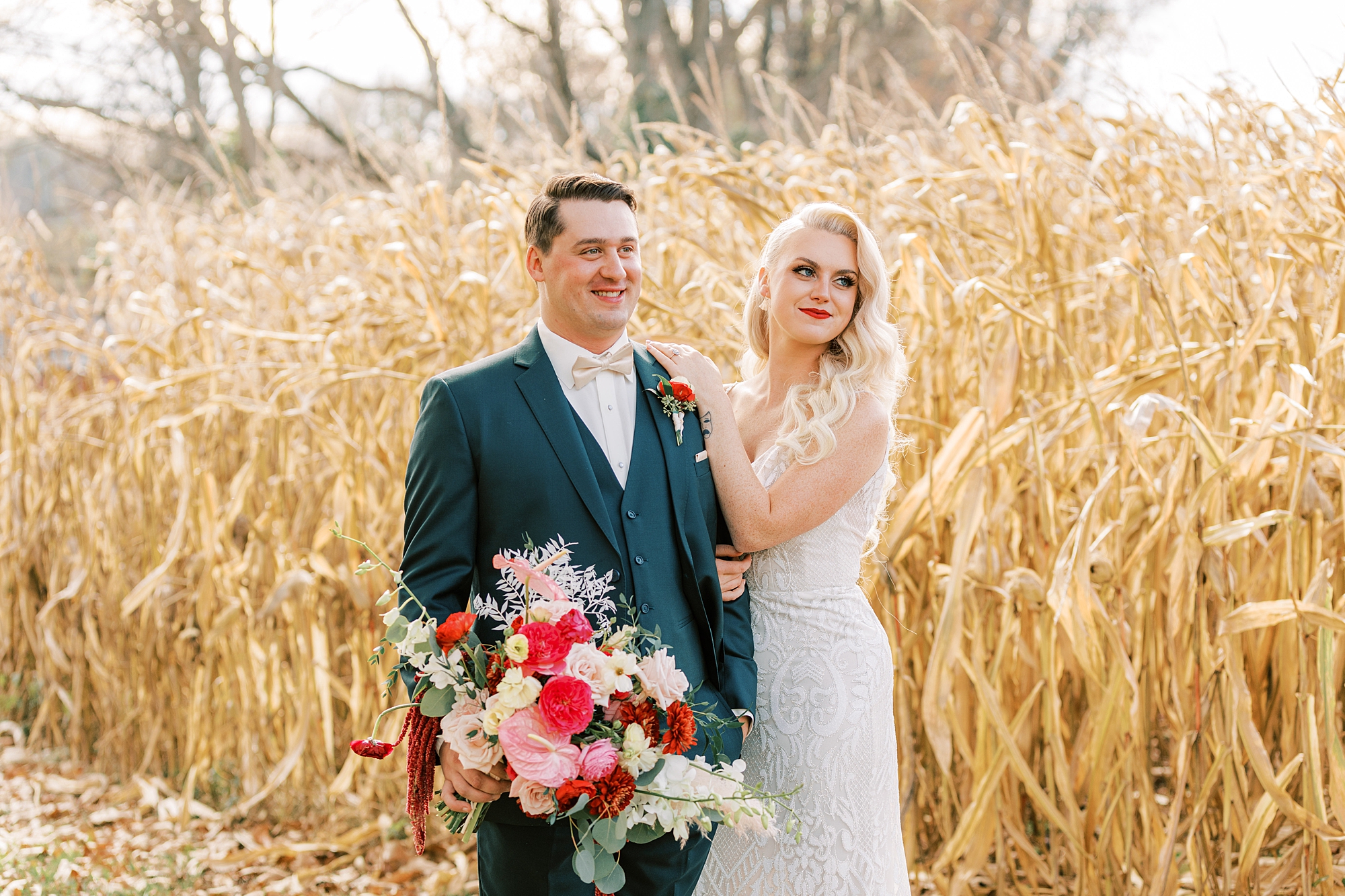 bride stands with groom placing arms on his shoulder at Osbornia Farm