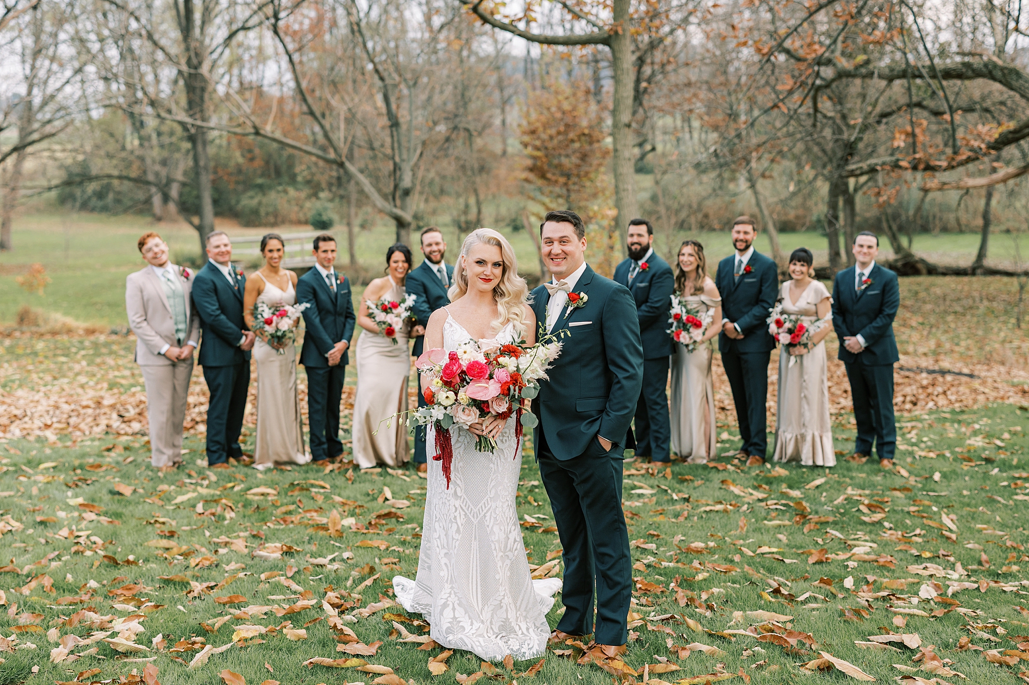 bride and groom hug standing in front of wedding party at Osbornia Farm