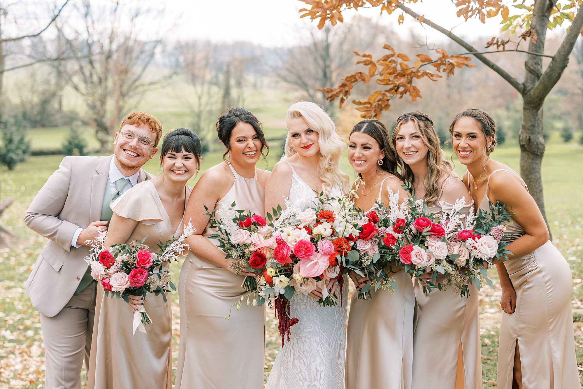 bride and wedding party hug on lawn at Osbornia Farm