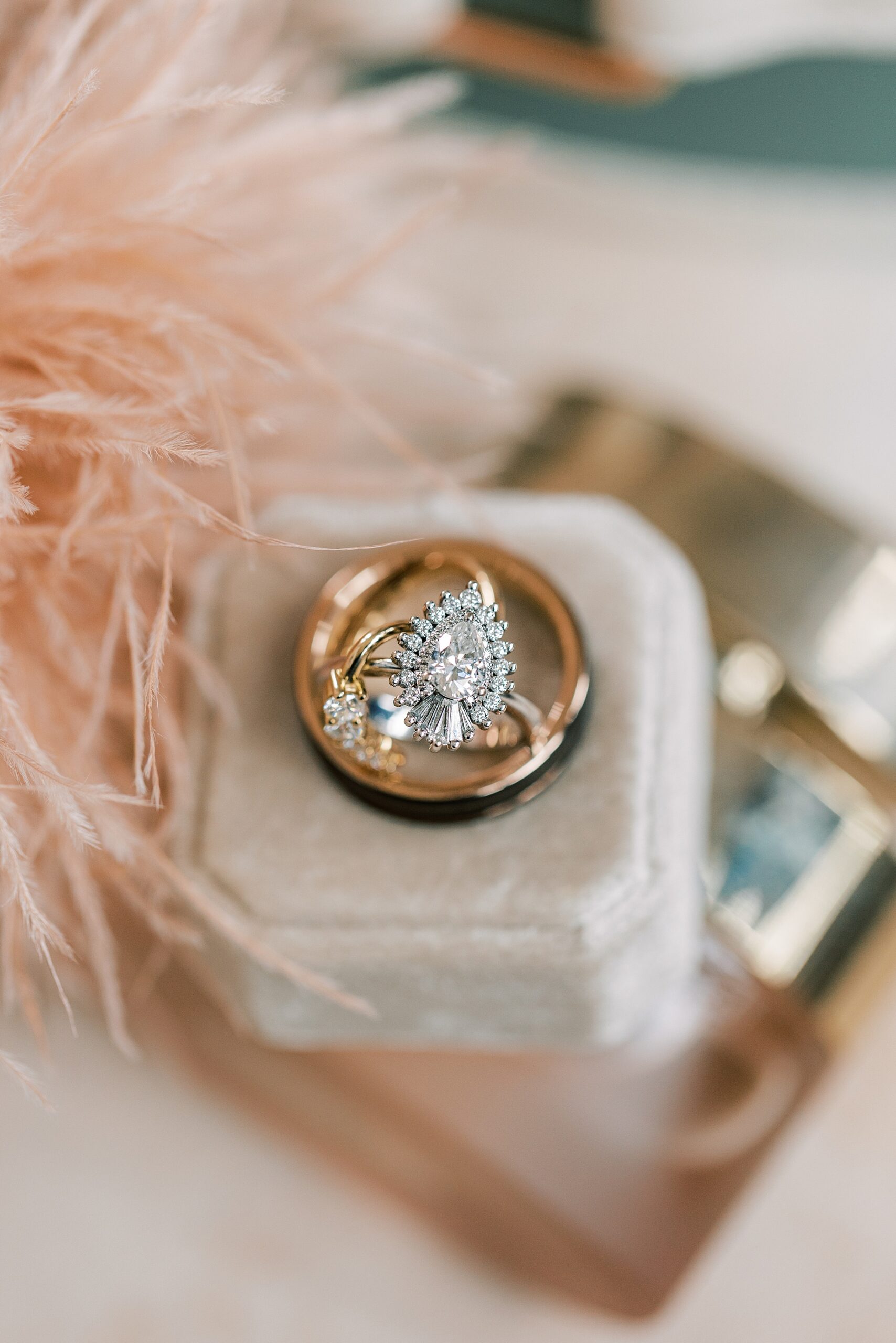 wedding rings rest on ivory ring box