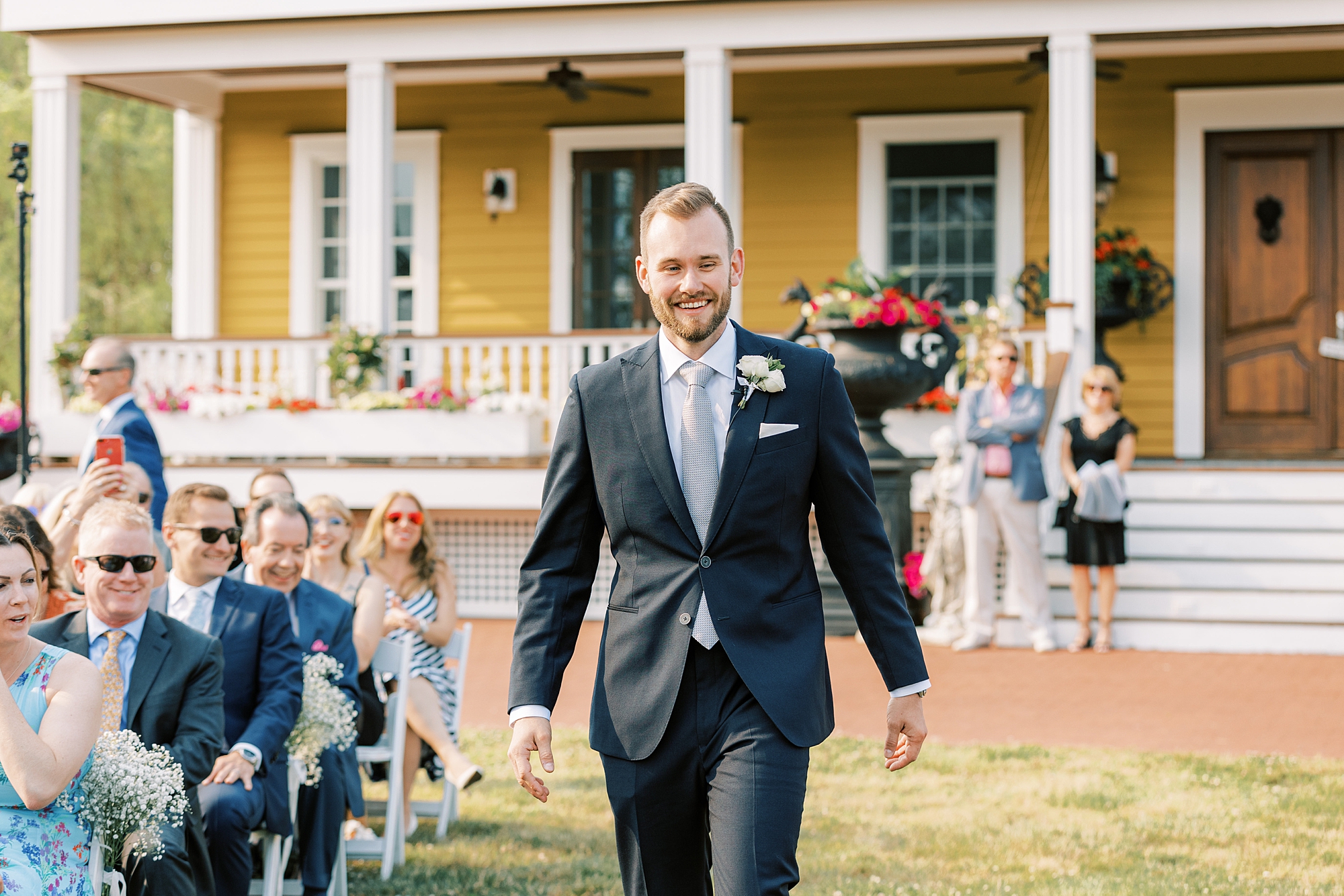 groom walks down aisle for ceremony at Willow Creek Winery
