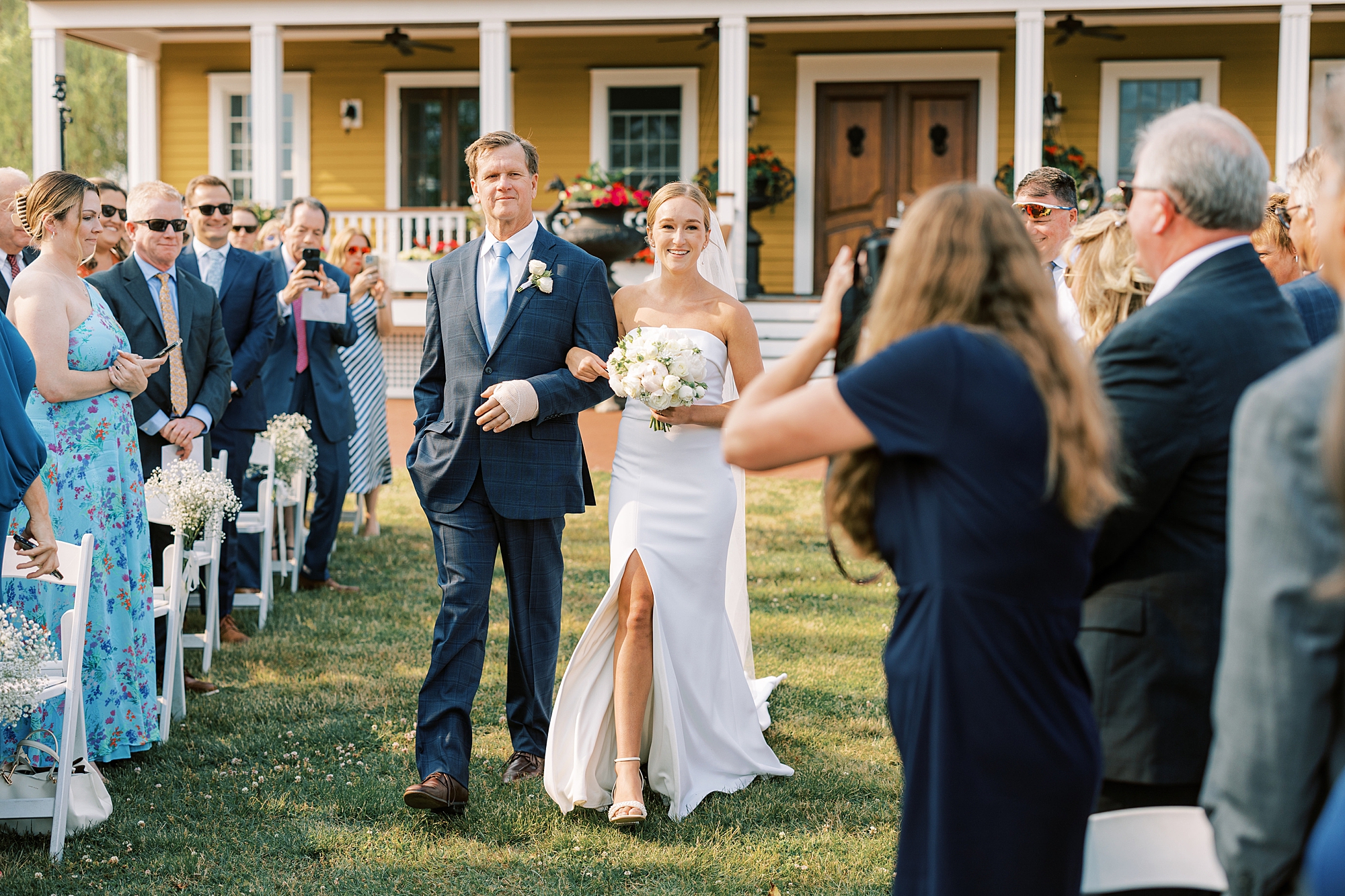 bride walks up aisle with father for wedding ceremony at Willow Creek Winery