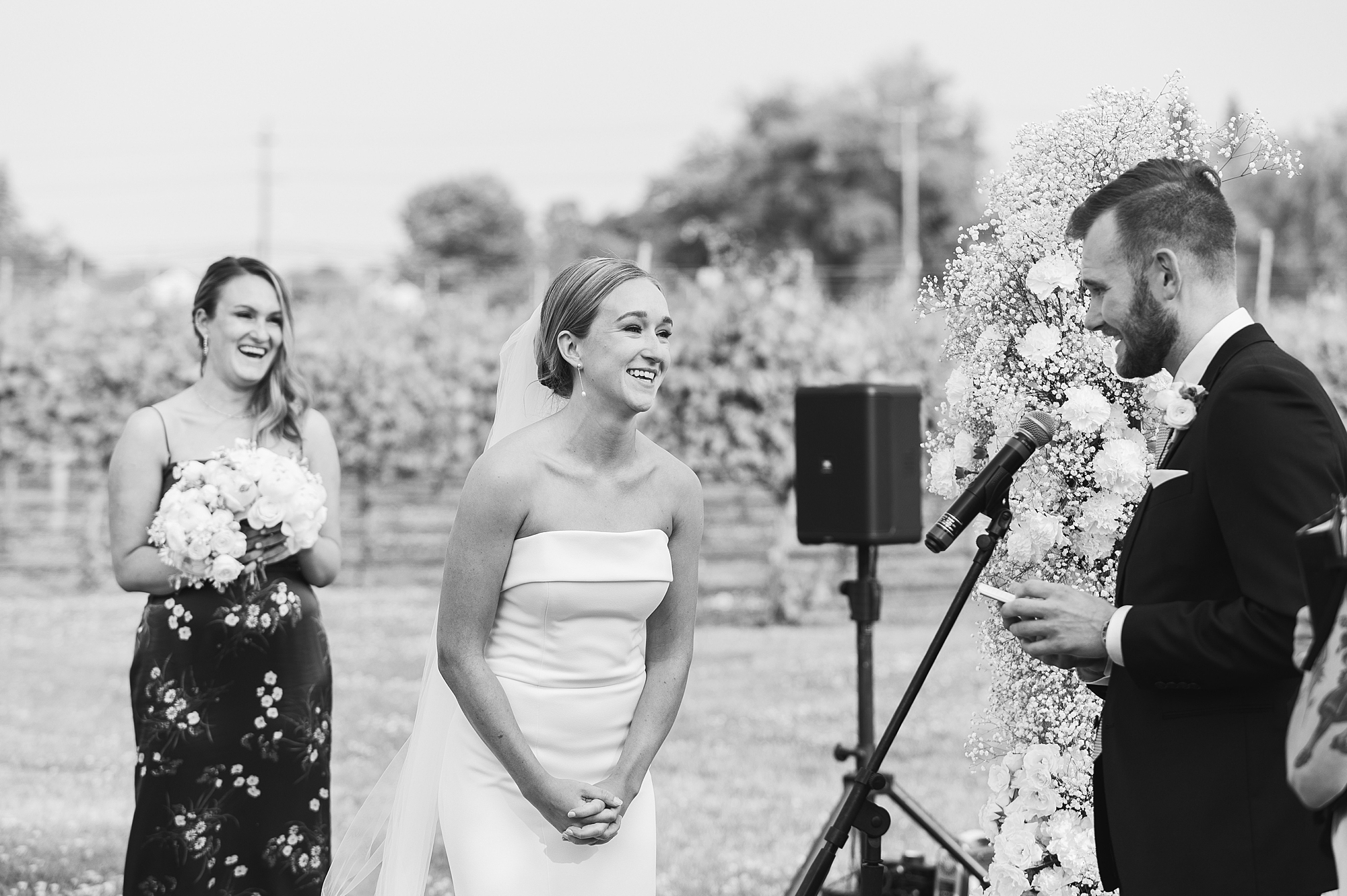 bride and groom laugh during wedding ceremony at Willow Creek Winery