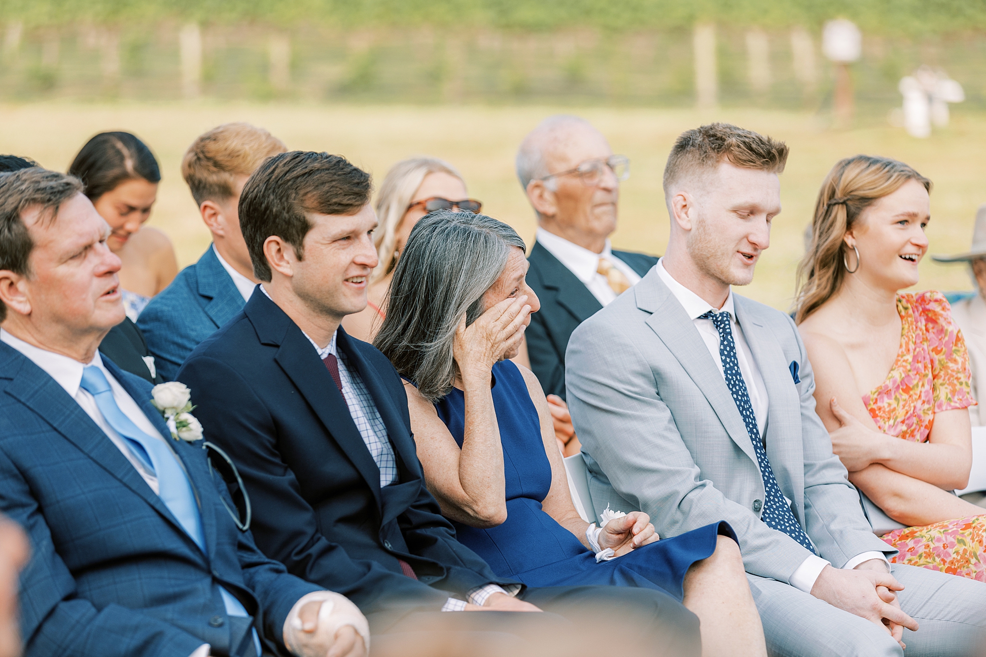 mother wipes eyes during wedding ceremony at Willow Creek Winery
