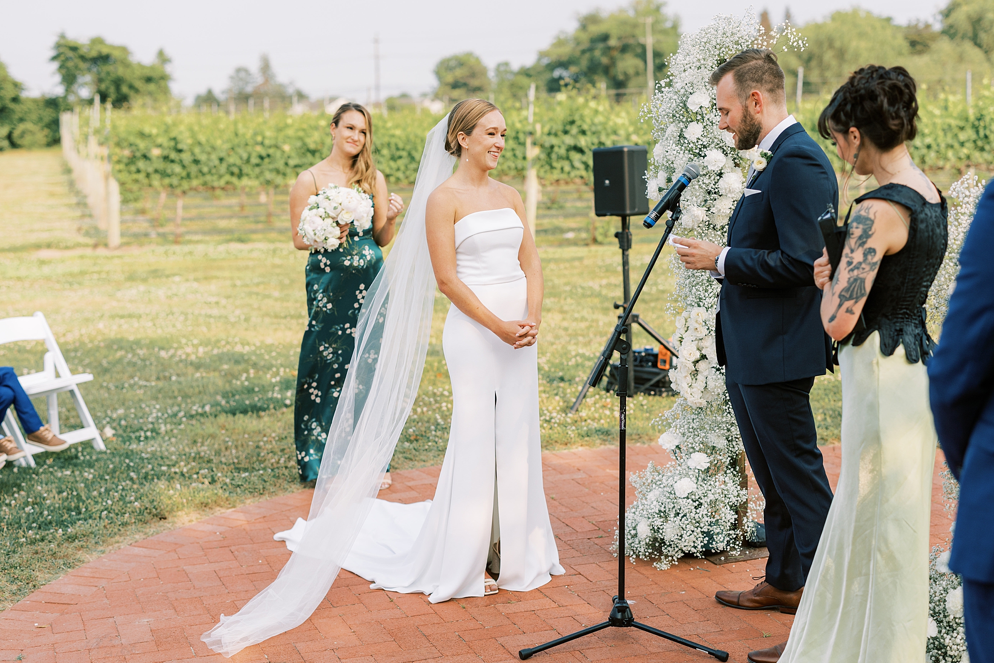 groom reads vows during wedding ceremony at Willow Creek Winery