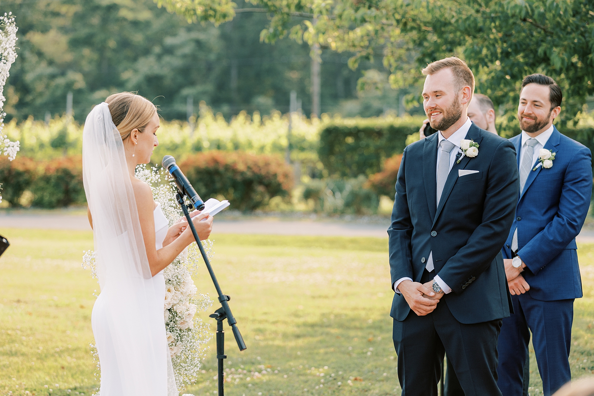 bride reads vows to groom during wedding ceremony at Willow Creek Winery