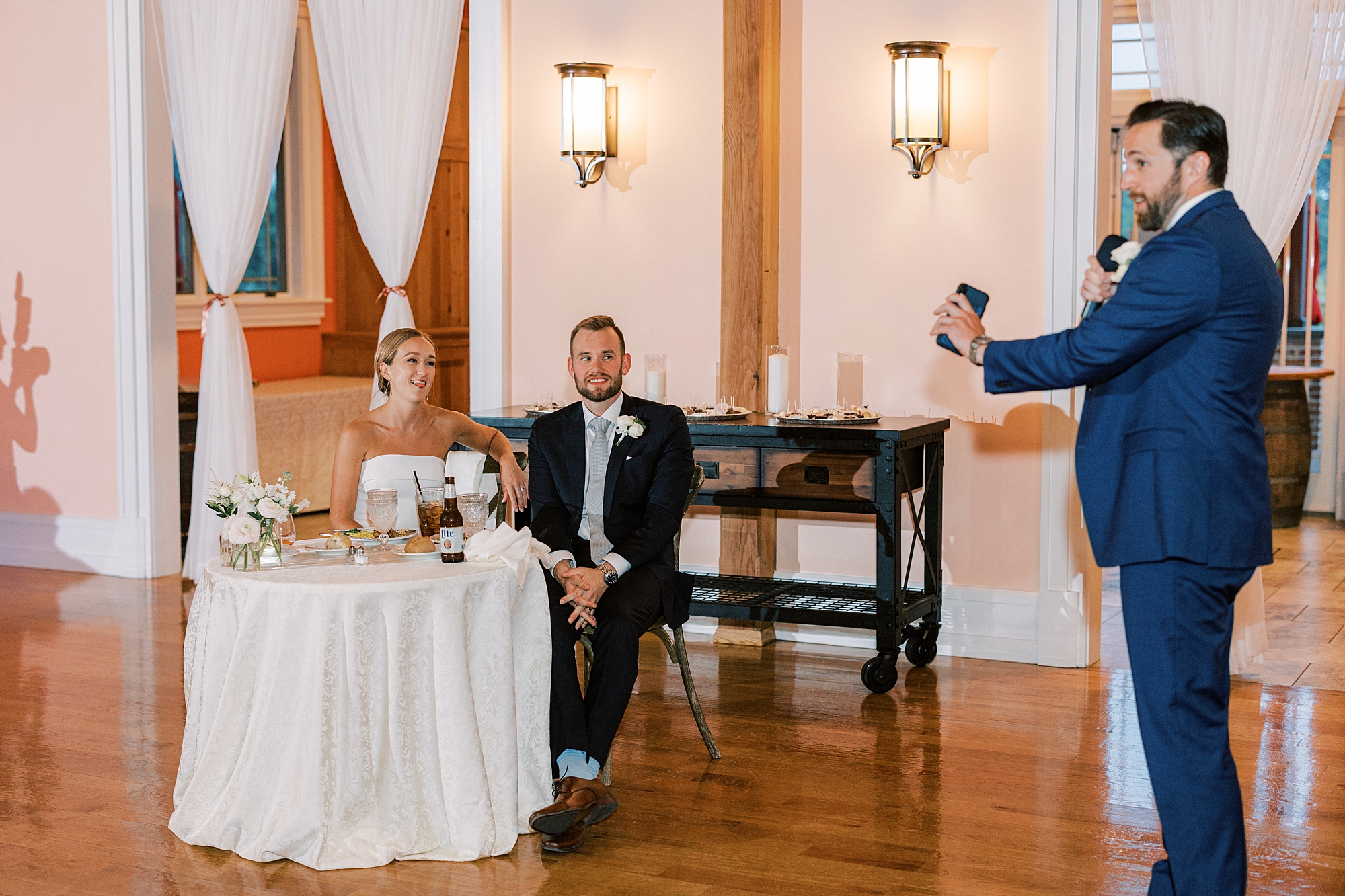 groomsman talks to newlyweds during speech at Willow Creek Winery wedding reception