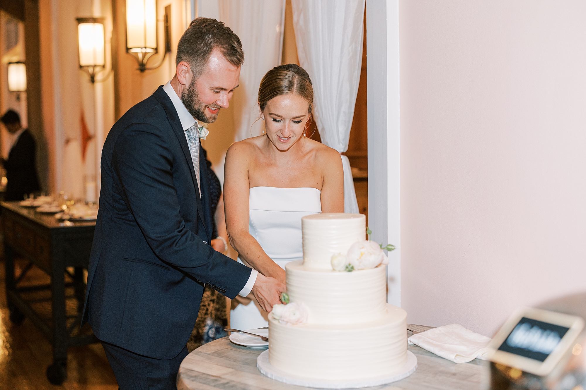 bride and groom cut wedding cake together during Willow Creek Winery wedding reception