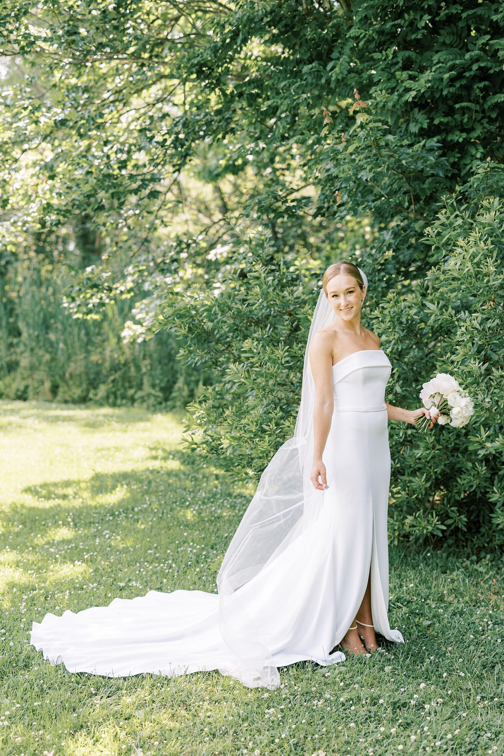 bride stands in front of trees at Willow Creek Winery