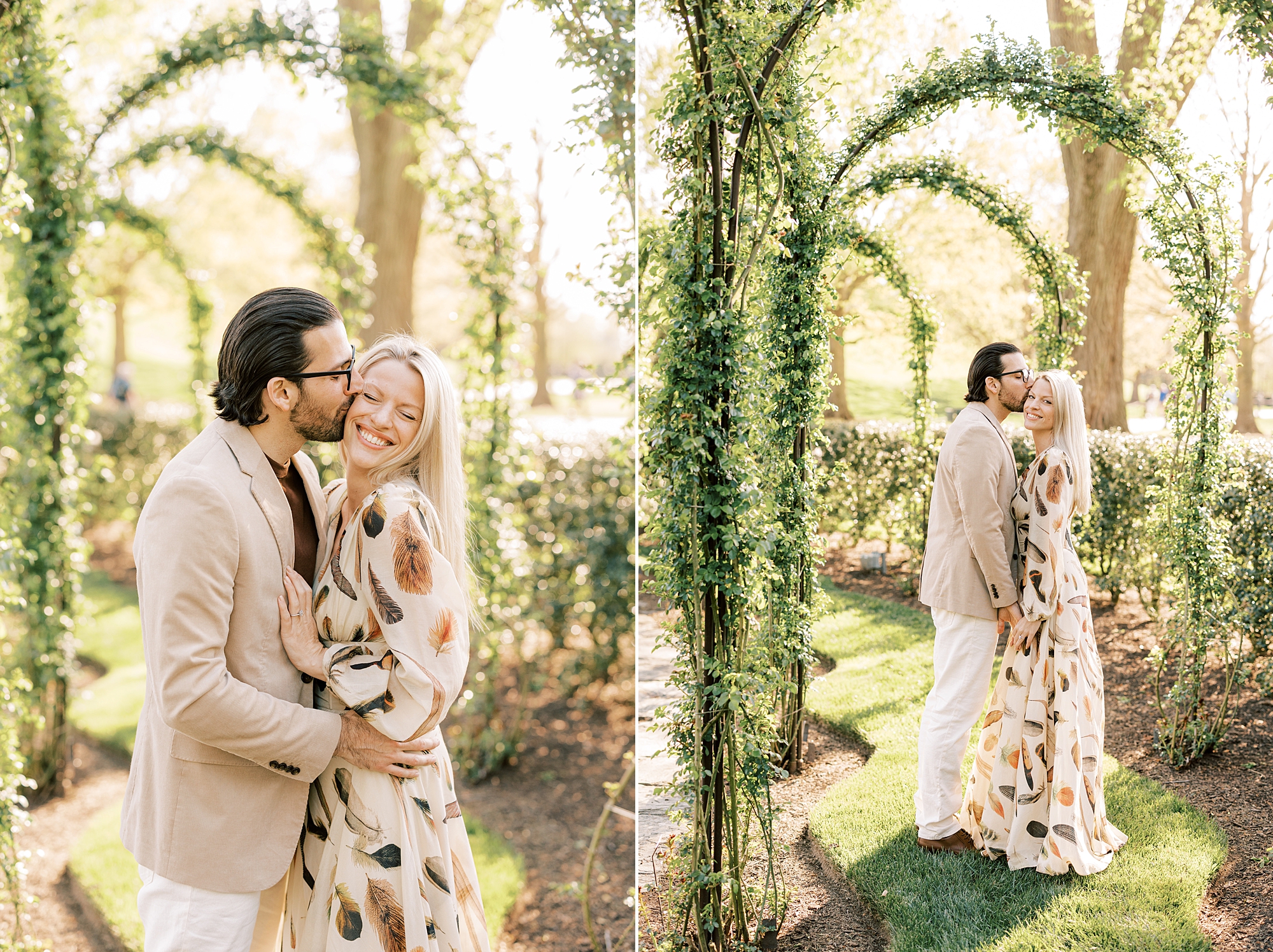 engaged couple hugs under greenery draped arbor inside Longwood Gardens
