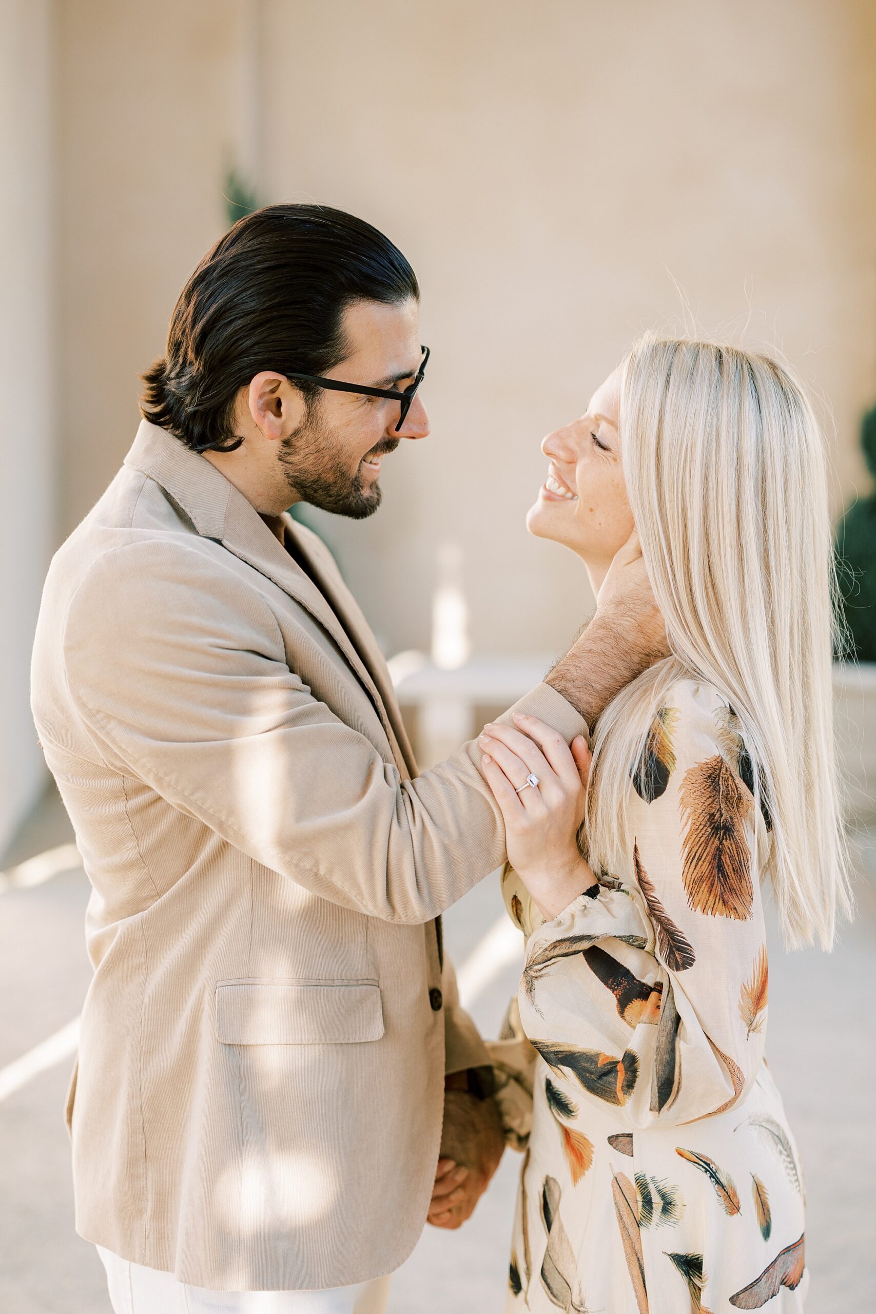 man holds woman's neck during engagement session at Longwood Gardens