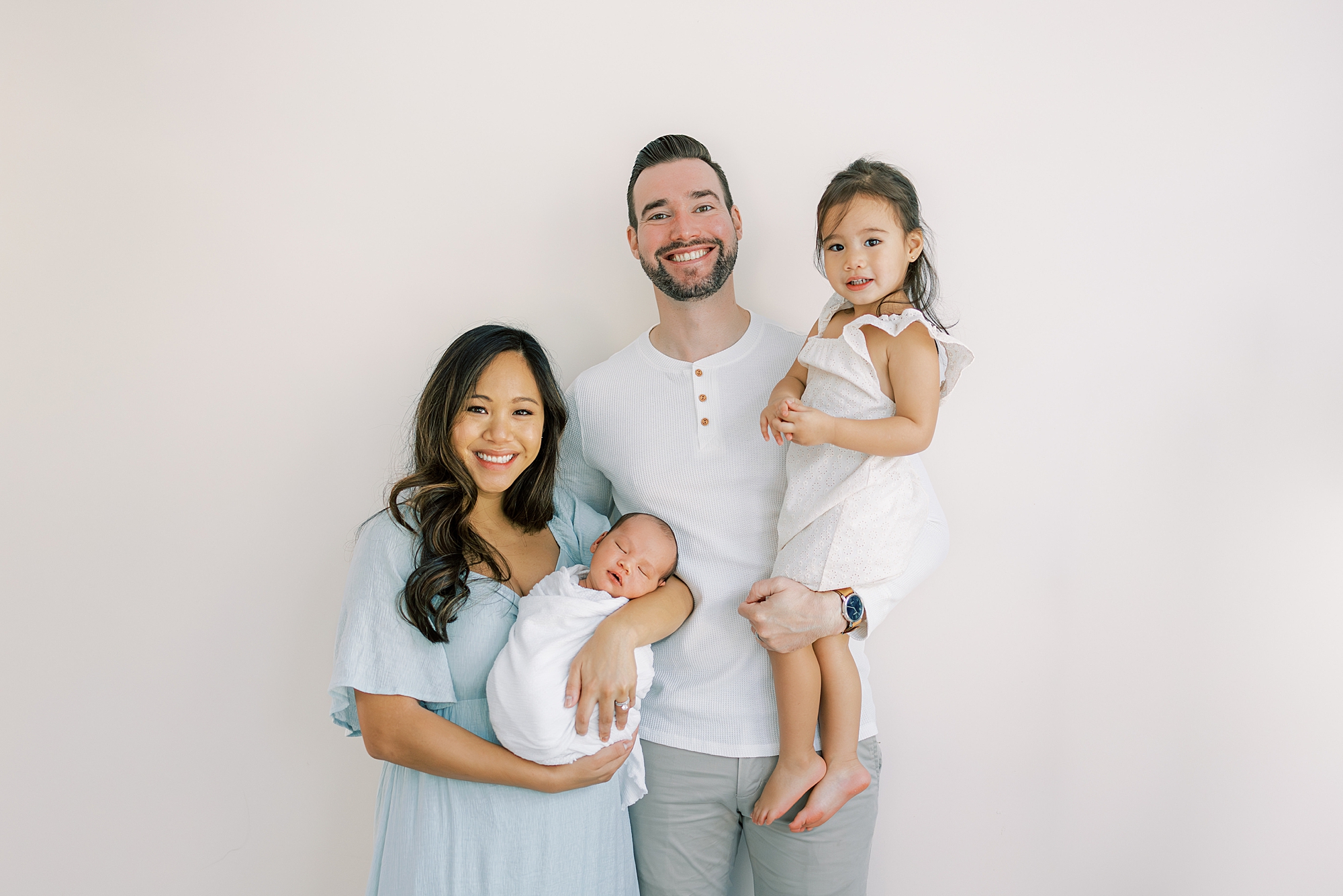 couple holds daughter and newborn son during NJ newborn session