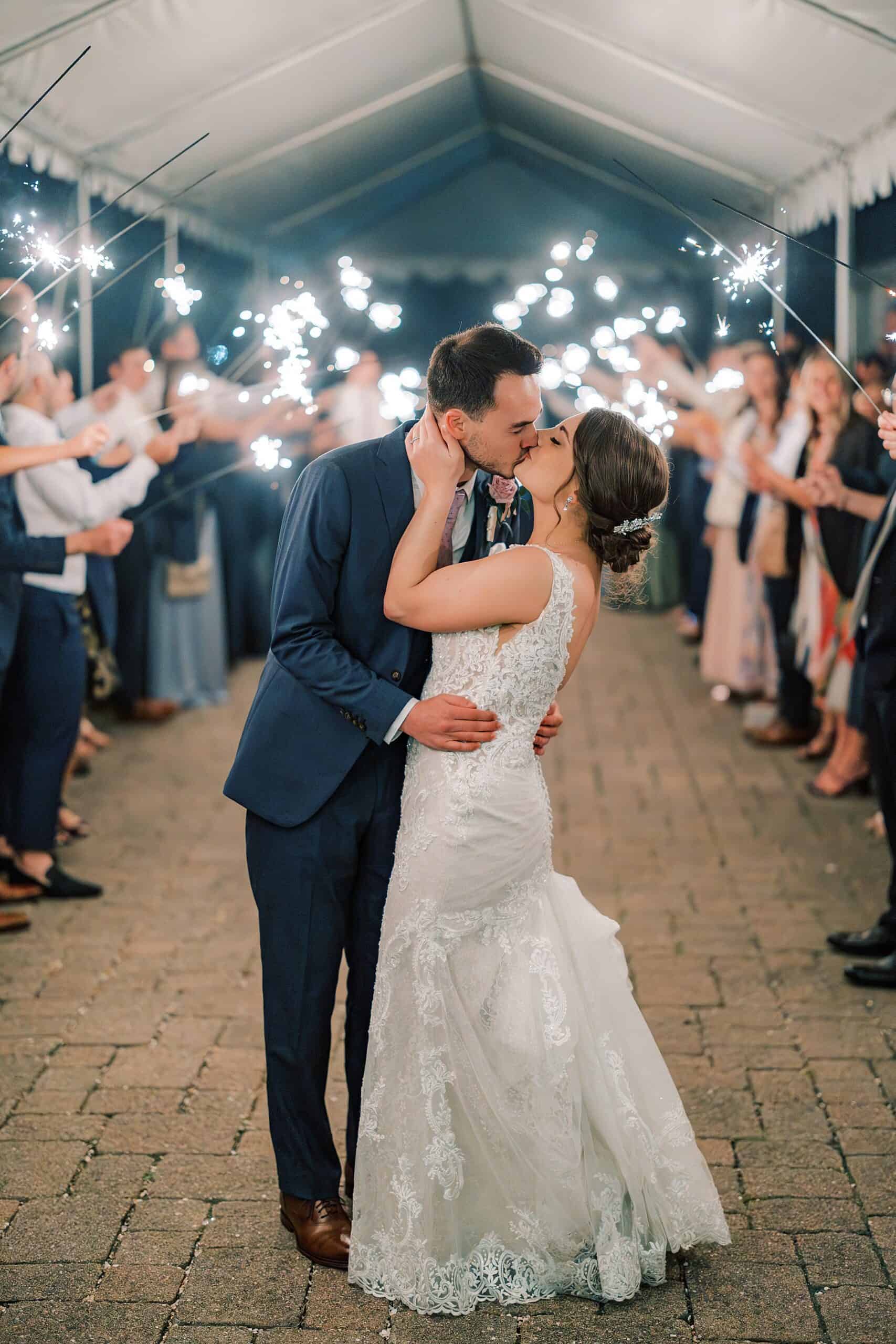 bride and groom kiss during their Perkasie PA wedding reception during their sparkler send off