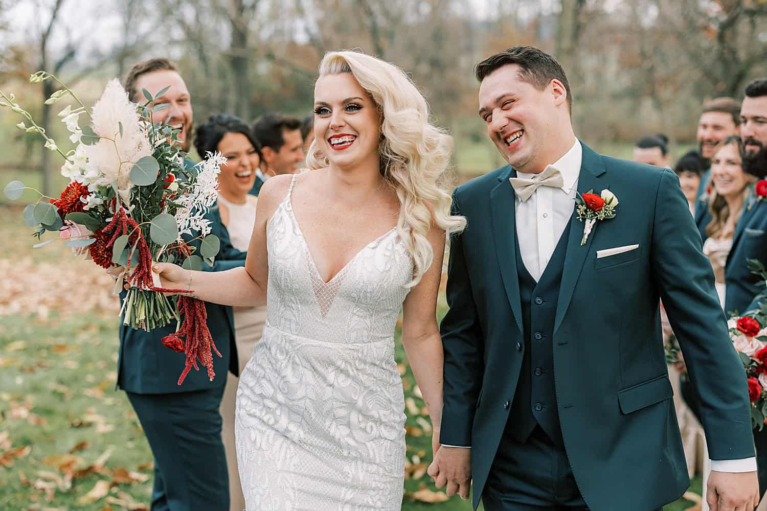 newlyweds hug with wedding party around them at Osbornia Farm