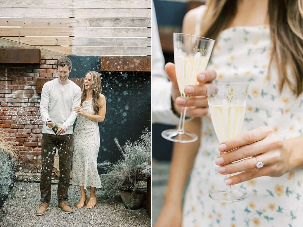 a man pops champagne in an urban setting as his fiance holds on to his arm and laughs towards him