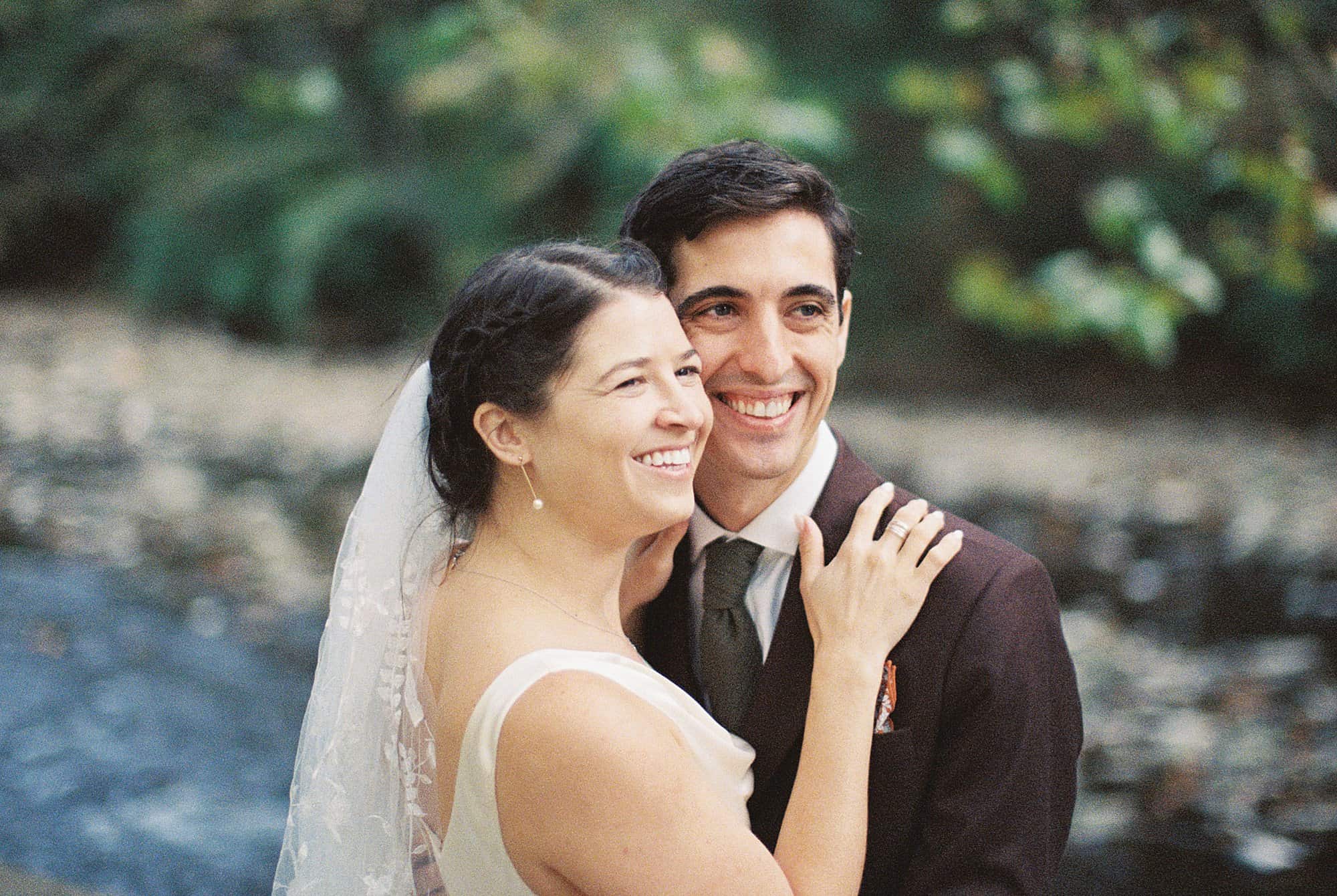 a film photography image of a bride and groom embracing in nature