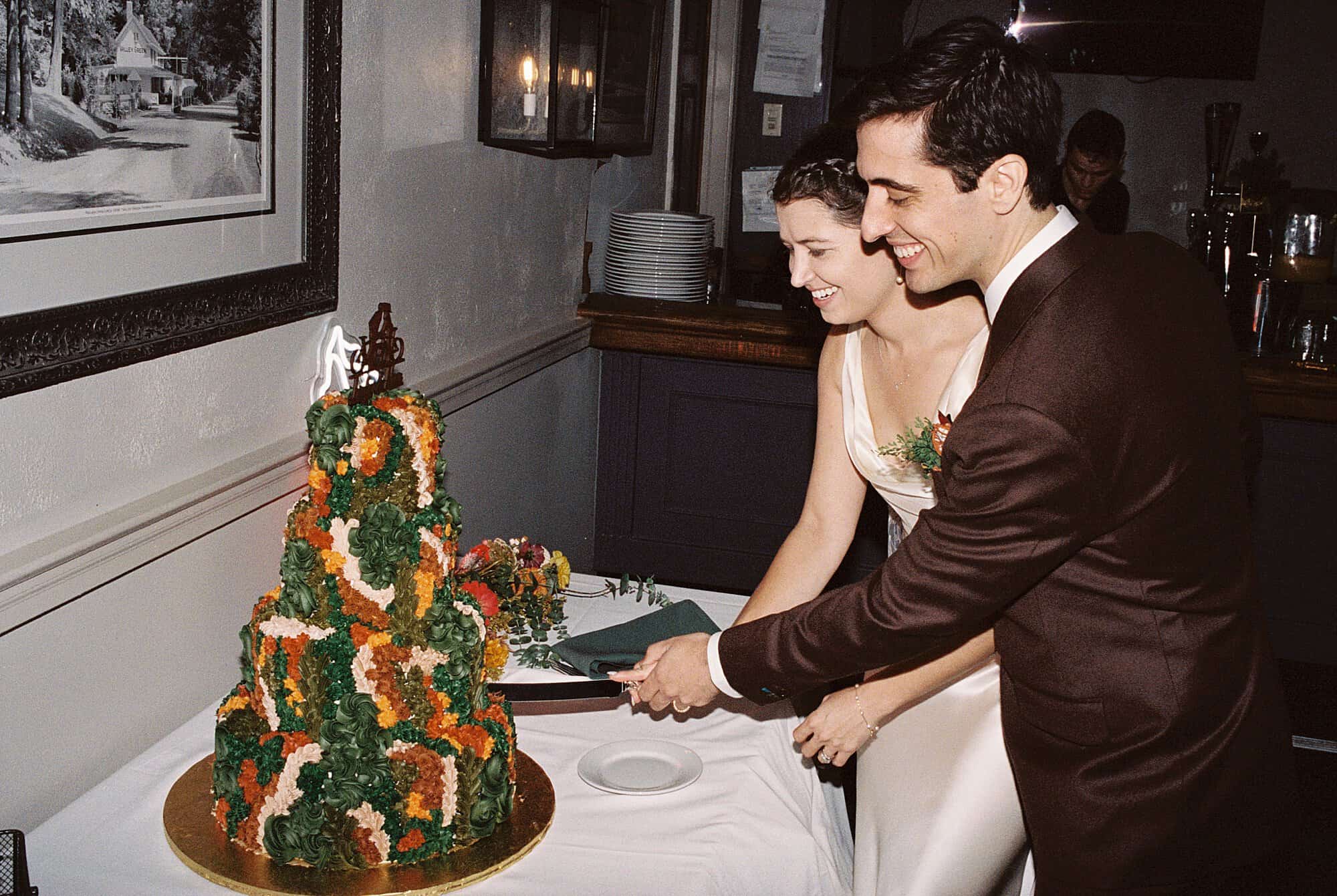 a bride and groom cut their cake