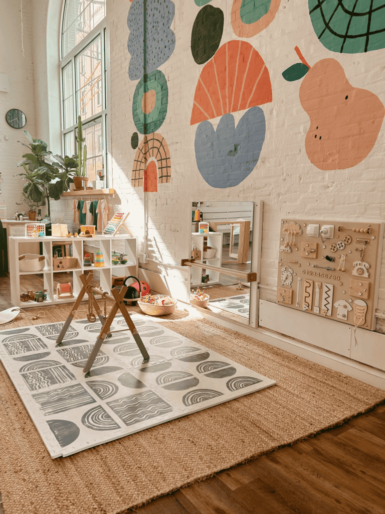 a colorful indoor playground with a modern and playful mural on the wall and Montessori toys called Kith and Kin located in Philadelphia PA