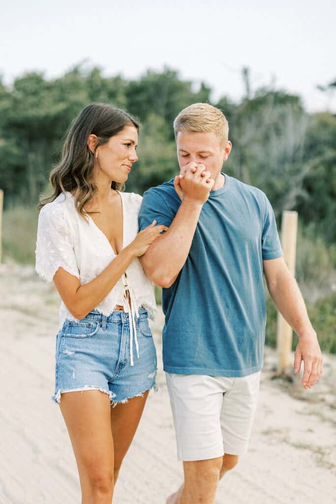 Laughing couple sharing candid moment during summer engagement photoshoot at Rehoboth Beach