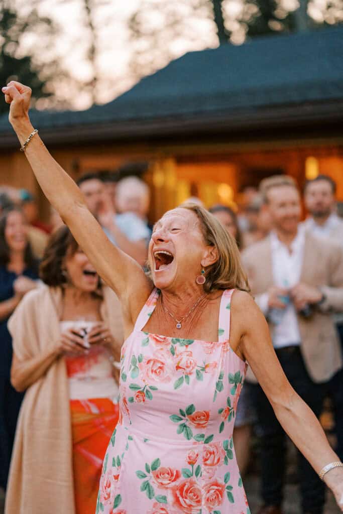 Joyful wedding guest celebrating during an outdoor rehearsal dinner at Skytop Lodge in Skytop, Pennsylvania