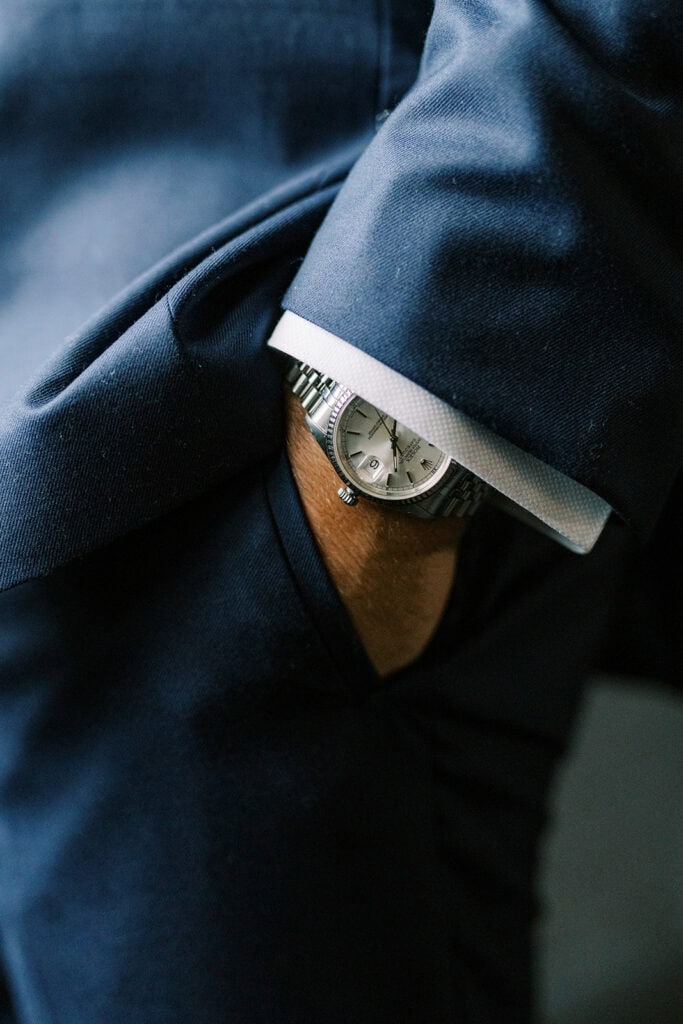 Close-up detail of groom's watch and navy suit cuff on wedding day at Skytop Lodge in Skytop, Pennsylvania
