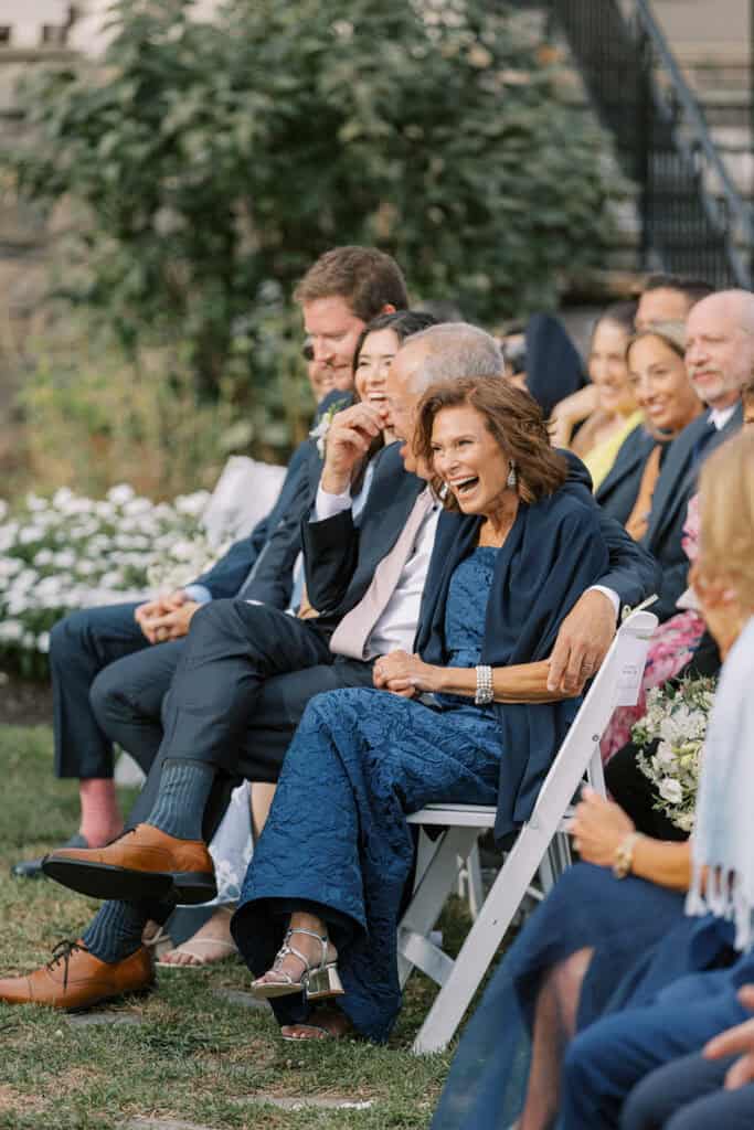 Wedding guests laughing during the outdoor ceremony at Skytop Lodge in Skytop, Pennsylvania