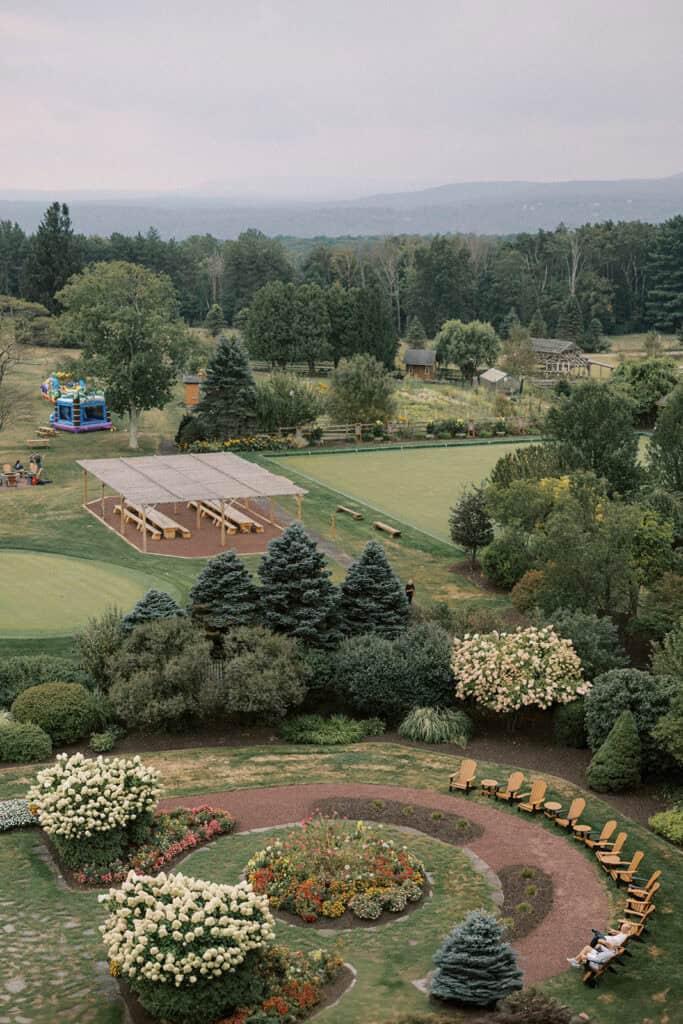 Aerial view of Skytop Lodge wedding grounds with manicured gardens, lawn games, and mountain views in the Pocono Mountains, Pennsylvania