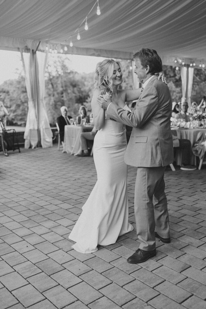 Black and white photo of bride and father sharing father daughter dance at Drumore Estate summer wedding reception in Pequea PA