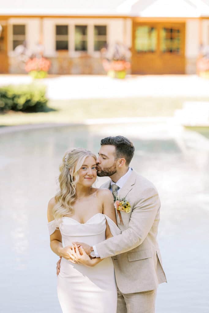 Bride and groom portrait by the fountain at Drumore Estate Pequea PA summer wedding venue with summer wedding color palette florals