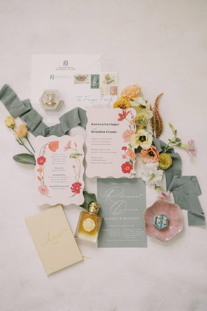 Floral wedding invitation suite with wildflower design vow book and gold rings for Drumore Estate summer wedding in Pequea Lancaster County PA