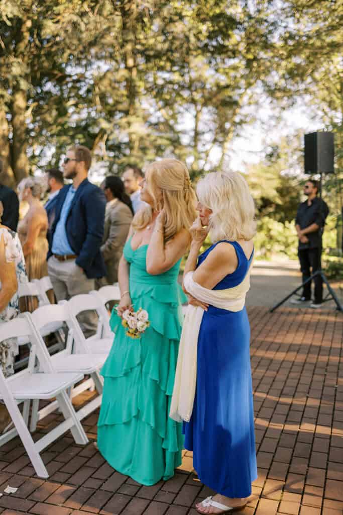 Mother of the bride and grandmother sharing an emotional moment during outdoor ceremony at Drumore Estate wedding in Lancaster Pennsylvania