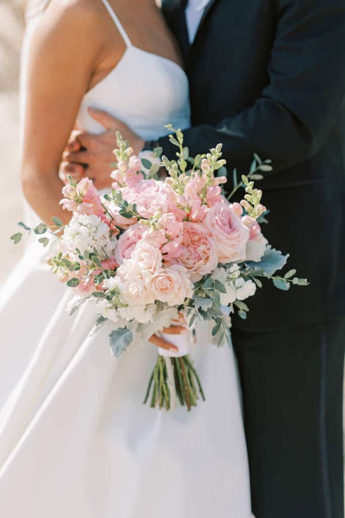 Close-up of blush pink bridal bouquet with garden roses, snapdragons, and eucalyptus at Rehoboth Beach Delaware wedding