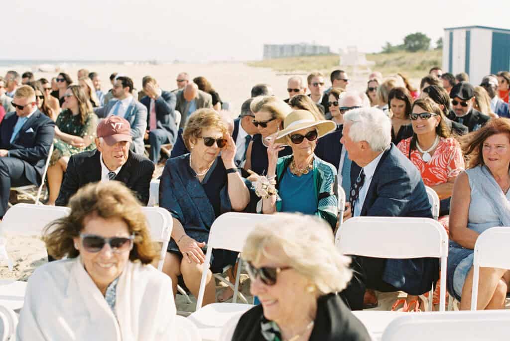 Guests seated at an outdoor beach ceremony at Rehoboth Beach, Delaware, photographed on film