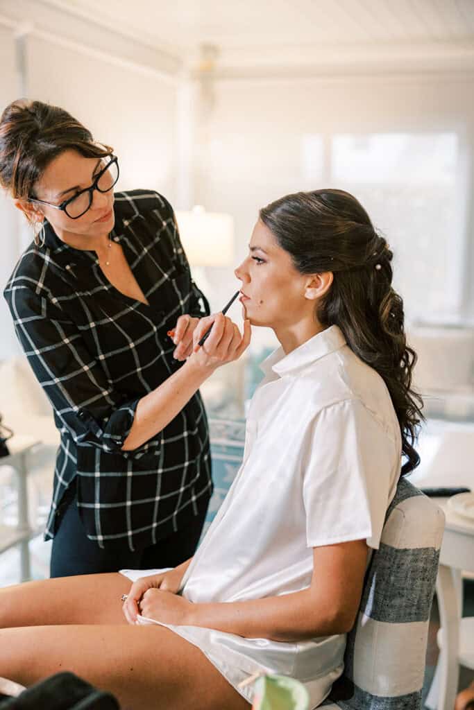 Bride having makeup applied during wedding morning getting ready at Rehoboth Beach, Delaware, photographed by Samantha Jay Photo