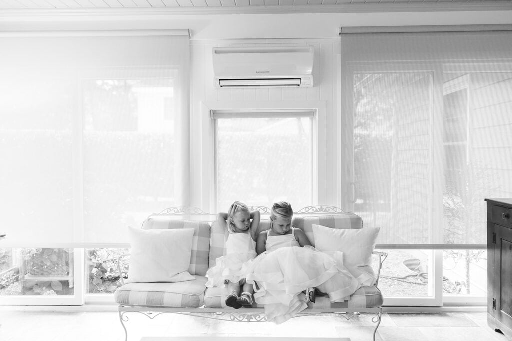 Black and white film photo of flower girls resting during Rehoboth Beach wedding getting ready, Samantha Jay Photo